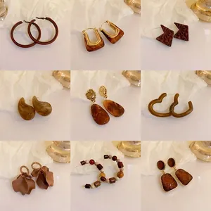 Collection of nine Maillard-style brown and gold earrings with various designs