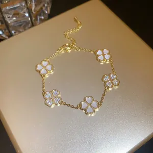 Detailed view of 18K gold plated bracelet with mother of pearl and zirconia clover motifs