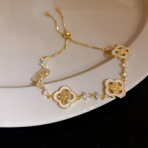 Detailed view of the 18K gold plated clover bracelet with shell inlay and zircon stones