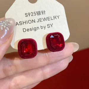 Detailed close-up showing red flocked geometric stud earrings with elegant S925 silver posts.