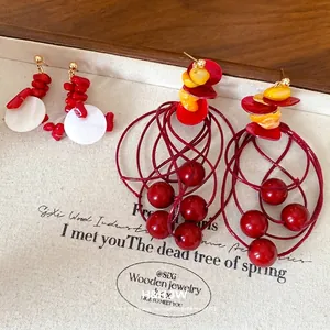 Red and yellow acrylic beaded geometric tassel earrings in a vintage stylish design.
