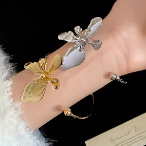 Elegant gold and silver metal flower open cuff bracelet for a stylish retro luxury look