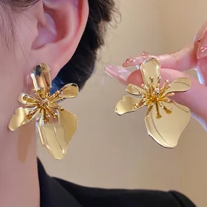 Elegant vintage gold metal flower stud earrings with minimalist luxury aesthetic for women