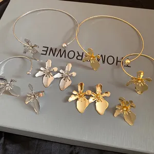 Detailed view of the vintage metallic flower jewelry set in elegant gold and silver tones.