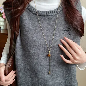 Detail view of a vintage minimalist resin pendant necklace in Maillard style aesthetic