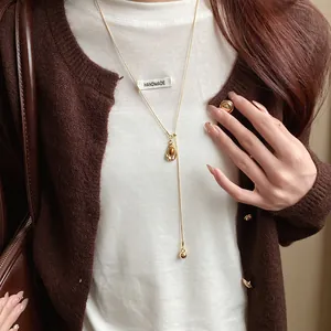 Detailed macro shot of an elegant vintage oval resin pendant necklace on a gold chain.
