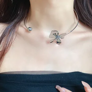Elegant close-up shot of a vintage metallic flower choker necklace on a model's neck