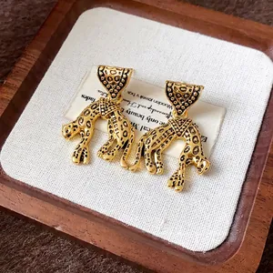 Vintage gold leopard triangle earrings with retro leopard spot details