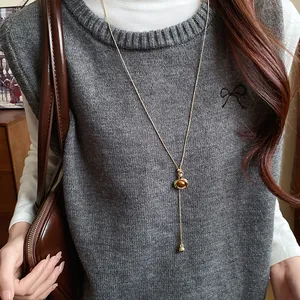 Detailed view of vintage oval resin pendant long necklace in Maillard brown style