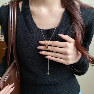 Detailed shot of a vintage Maillard style brown resin oval pendant necklace on model