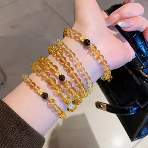 Vintage citrine and agate flower bracelets layered on wrist with a sophisticated aesthetic
