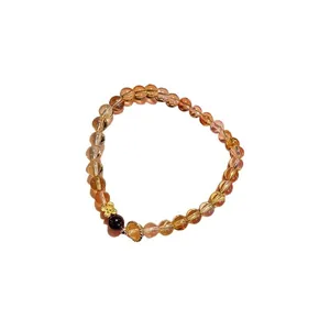 Vintage citrine and agate beaded bracelet featuring a gold flower and a fan-shaped charm accessory