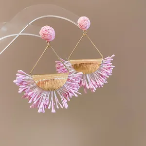 Elegant pink flower stud earrings with golden triangle frame and fringe detail.