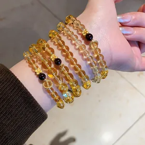 Close-up view of elegant yellow citrine and red garnet bracelets with gold flowers