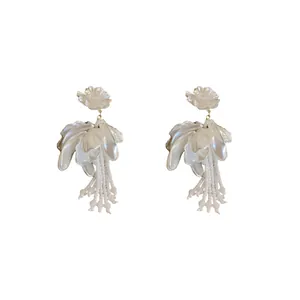 Elegant white flower petal earrings with hanging crystal tassels for a French chic look.