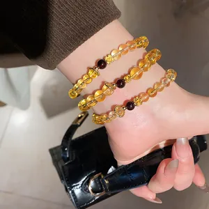 Macro view of yellow crystal and agate bracelets with elegant golden flower charms