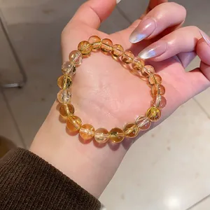 Close-up of a citrine agate beaded bracelet on a hand with Maillard style aesthetic.