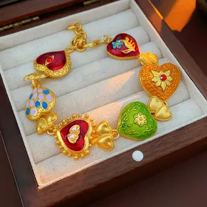 Vintage colorful heart charm bracelet with gold finish in a jewelry display box