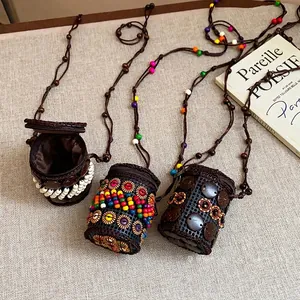 Bohemian ethnic coconut shell necklaces and mini pendants on a textured linen background.