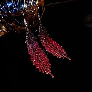 Elegant rhinestone tassel feather earrings with gradient red crystals and silver hooks.