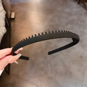 Detailed macro view of a matte black non-slip headband with comb teeth for daily face washing