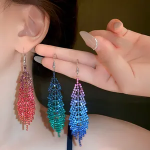 Detailed view of three colorful rhinestone geometric feather tassel dangle hook earrings