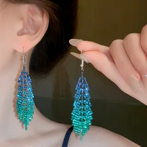 Detailed view of blue-green gradient rhinestone feather tassel drop earrings for women