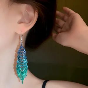 Detailed close-up view of elegant blue and green gradient rhinestone tassel earrings