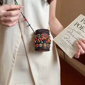 Close-up of bohemian ethnic coconut shell necklace with colorful beads on a model.
