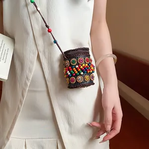Close-up detail of a Bohemian ethnic style cylindrical pouch necklace with colorful beads