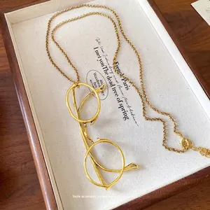 Elegant gold vintage spectacle pendant necklace featuring a minimalist fine link chain design