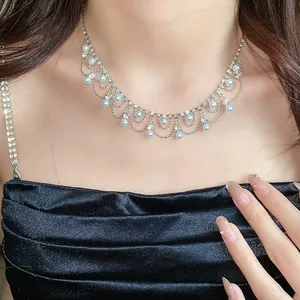Elegant rhinestone and blue pearl fringe necklace on model