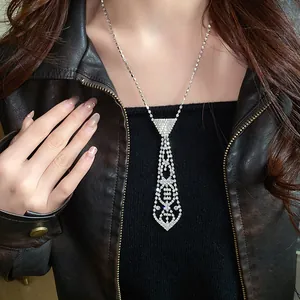 Close-up detail of a vintage-style rhinestone tie tassel necklace worn by a model