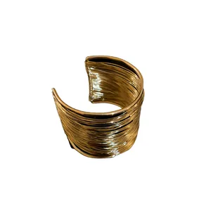 Statement multi-strand gold wire cuff bracelet featuring a minimalist open-ended design
