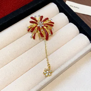 Sparkling firework brooch with red enamel petals and crystal accents in gold finish