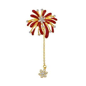 Elegant firework flower brooch with red enamel and sparkling crystals on gold plating