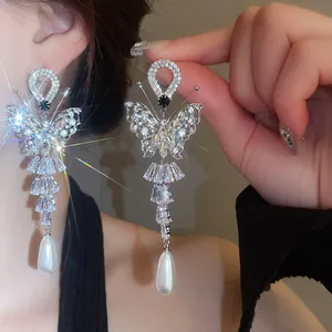 Sparkling crystal butterfly tassel earrings with teardrop pearl in silver finish
