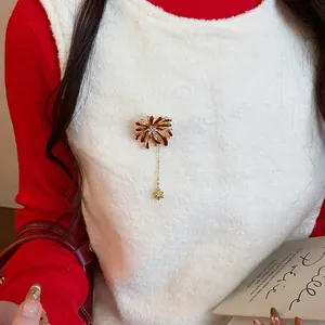 Elegant rhinestone firework flower brooch shown as a detail on a festive white vest.