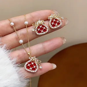 Detail of red fortune bag jewelry set with lustrous pearls and sparkling zircons