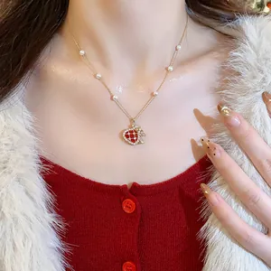 Detailed close-up of a luxury gold-plated fortune bag necklace with pearl accents and zircons