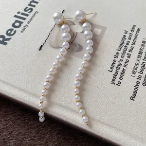 Elegant long pearl tassel earrings with silver needles and gold accents for women