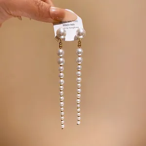 Elegant long pearl tassel earrings with S925 silver needles in a close-up detail view