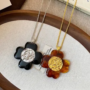 Vintage flower necklaces with wrinkled petal pendants in black and amber colors.