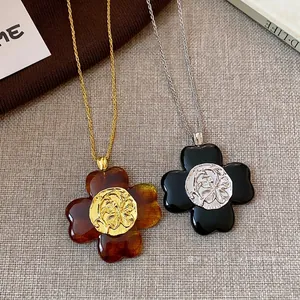 Vintage flower pendant necklace with textured round center for elegant women's jewelry