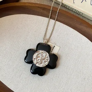 Close-up of vintage flower pendant necklace with wrinkled silver center on linen background