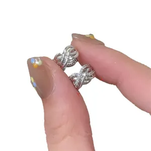 Sparkling cubic zirconia crossover hoop earrings in silver-toned elegant jewelry design.