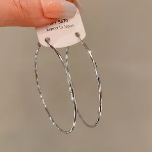 Silver textured hoop earrings with hammered metal finish detail