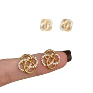 Elegant gold openwork flower stud earrings with sparkling zircon stones for women