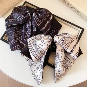 Vintage paisley bow hair clips in black and cream for elegant styling