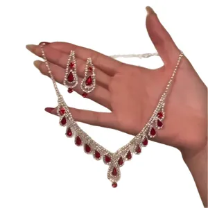 Silver-tone jewelry set including a necklace and earrings with red teardrop rhinestones